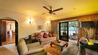 Seafront suite at Casa del Mar Langkawi, Malaysia, featuring cozy living area and private balcony overlooking the Andaman Sea
