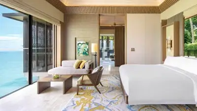 Ocean-view villa at The Ritz-Carlton Langkawi in Malaysia, featuring contemporary interiors and floor-to-ceiling windows overlooking the Andaman Sea