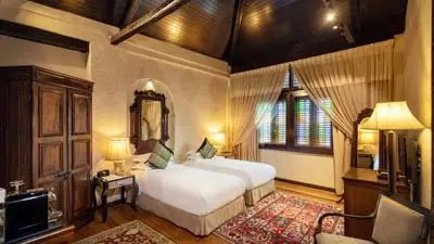 Heritage-style guest room at Campbell House in George Town, Penang, Malaysia, featuring wooden beams and colonial-era décor in a restored boutique hotel