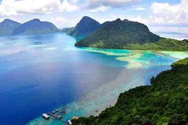 Aerial view of turquoise reefs and forested islands off Kota Kinabalu, showcasing a coastal island-hopping tour experience in Sabah, Malaysia