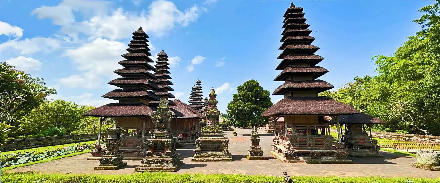 Pura Taman Ayun temple complex in Bali, Indonesia, featuring iconic multi-tiered meru towers set within tranquil gardens and traditional Balinese architecture.