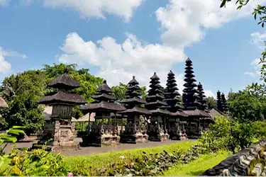 Pura Taman Ayun temple in Bali, Indonesia, featuring iconic multi-tiered meru towers surrounded by serene gardens and traditional Balinese architecture.