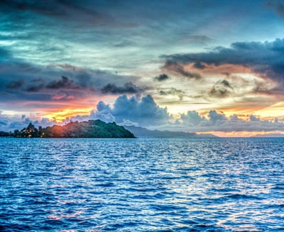 Sunset over the Gili Islands near Lombok, Indonesia, featuring turquoise waters, dramatic tropical skies, and the serene beauty of this popular island escape.