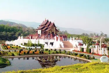 Royal Pavilion (Ho Kham Luang) at Royal Park Rajapruek in Chiang Mai, Thailand, featuring traditional Lanna architecture, manicured gardens, and reflecting ponds set against a mountainous backdrop.