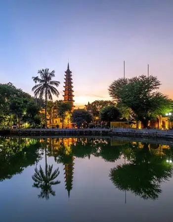 Tran Quoc Pagoda reflected on West Lake at sunset in Hanoi, Vietnam, showcasing one of the city’s oldest and most revered Buddhist landmarks.