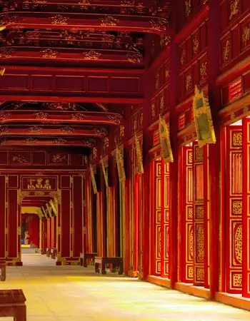 Vibrant red corridors inside the Hue Imperial City, Vietnam, highlighting ornate Nguyen Dynasty design and the rich cultural heritage of this historic royal complex.