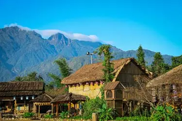 Traditional village homes in Sapa, Vietnam, set against misty mountain peaks, reflecting the region’s rich ethnic heritage and serene highland landscapes.
