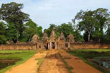 Historic Khmer temple entrance at Banteay Srei surrounded by lush greenery