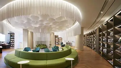 Modern lobby lounge at Lahan Select Gyeongju featuring circular green seating, elegant lighting, and contemporary design in the historic city of Gyeongju, South Korea.