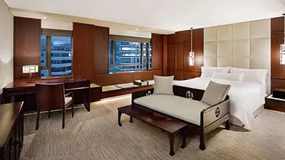 Elegant guest room at The Westin Josun Seoul featuring modern furnishings, large windows with city views, and refined luxury accommodations in central Seoul, South Korea.