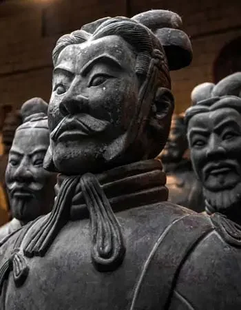 China_350-450_Terra_Cotta_Warriors Terracotta Warriors in Xi’an with detailed stone armor and solemn expressions inside the ancient burial complex.