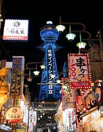 Japan_350-450_Osaka_Shinsekai1 Tsutenkaku Tower overlooking the neon-lit food district of Shinsekai in Osaka, Japan